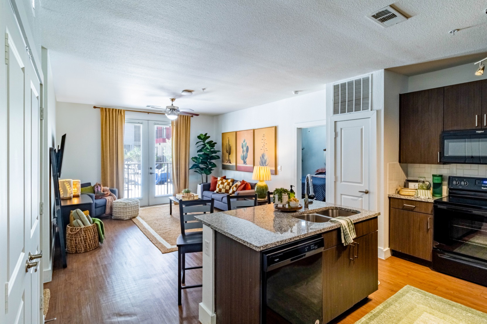 Kitchen and living room of model apartment at Pointe San Marcos