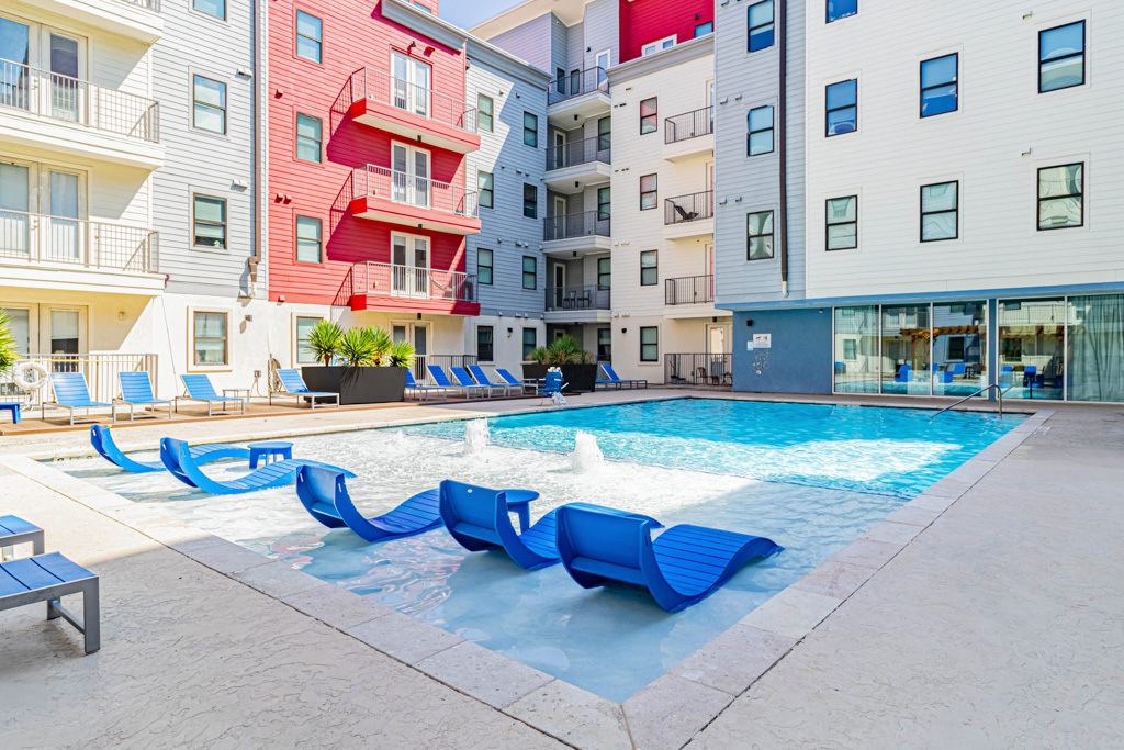 Ledge lounge chairs in the resort style swimming pool at Pointe San Marcos