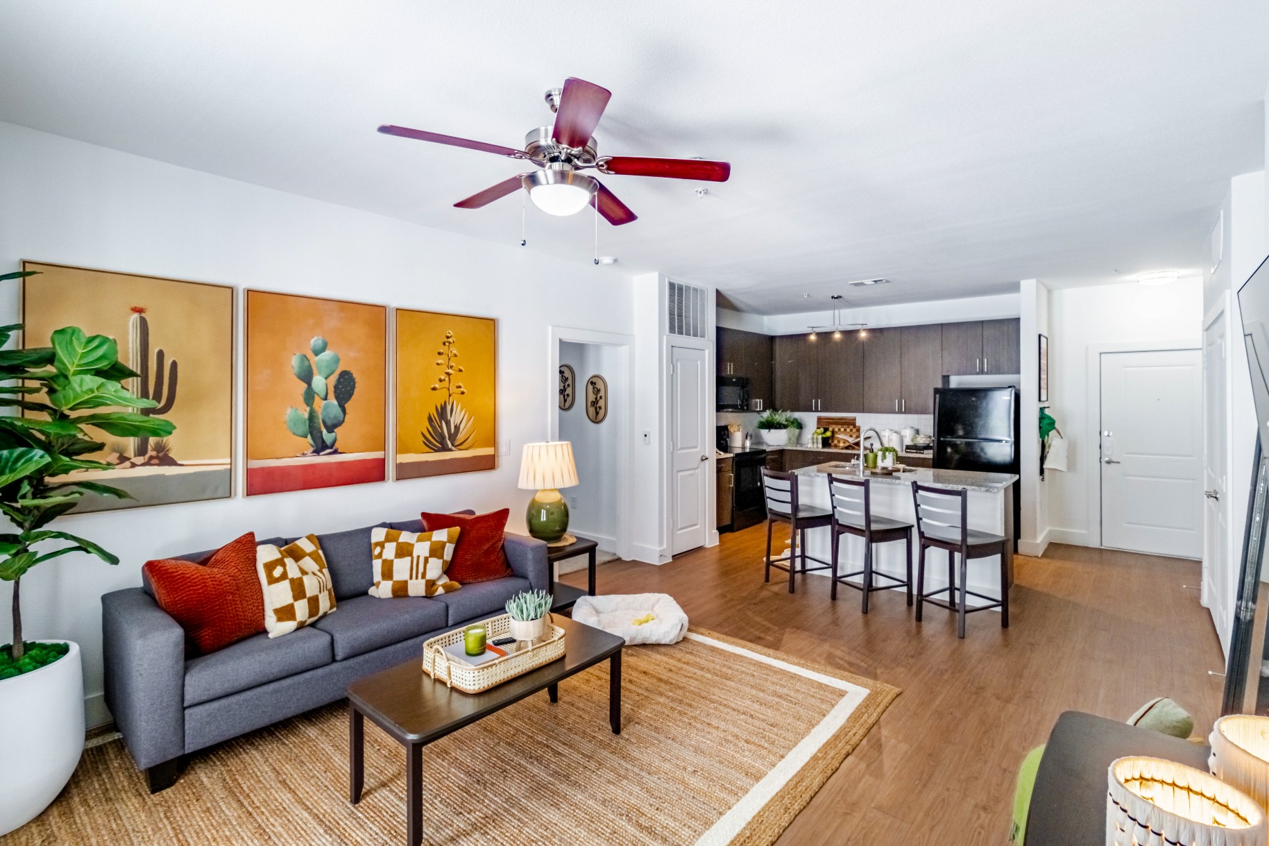 Living room and open kitchen in a model apartment at Pointe San Marcos