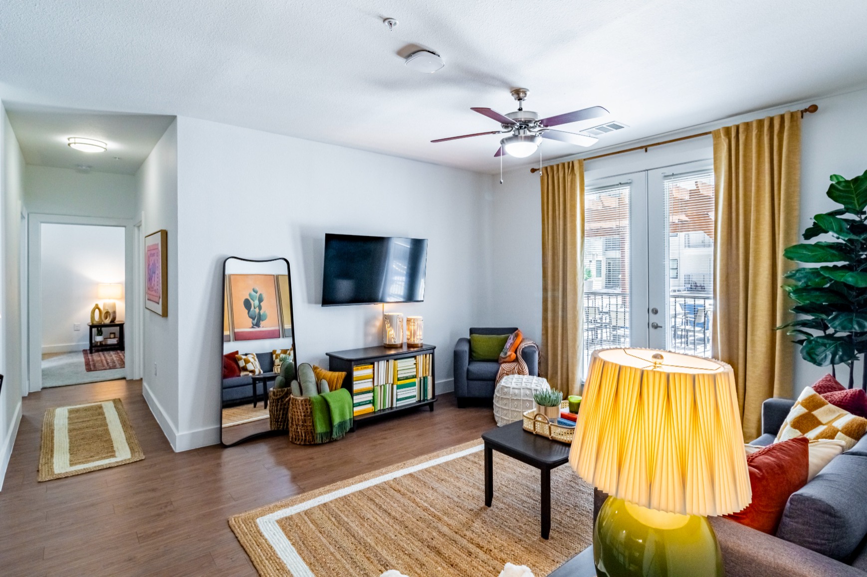 Living room with wood style flooring and ceiling fan at Pointe San Marcos