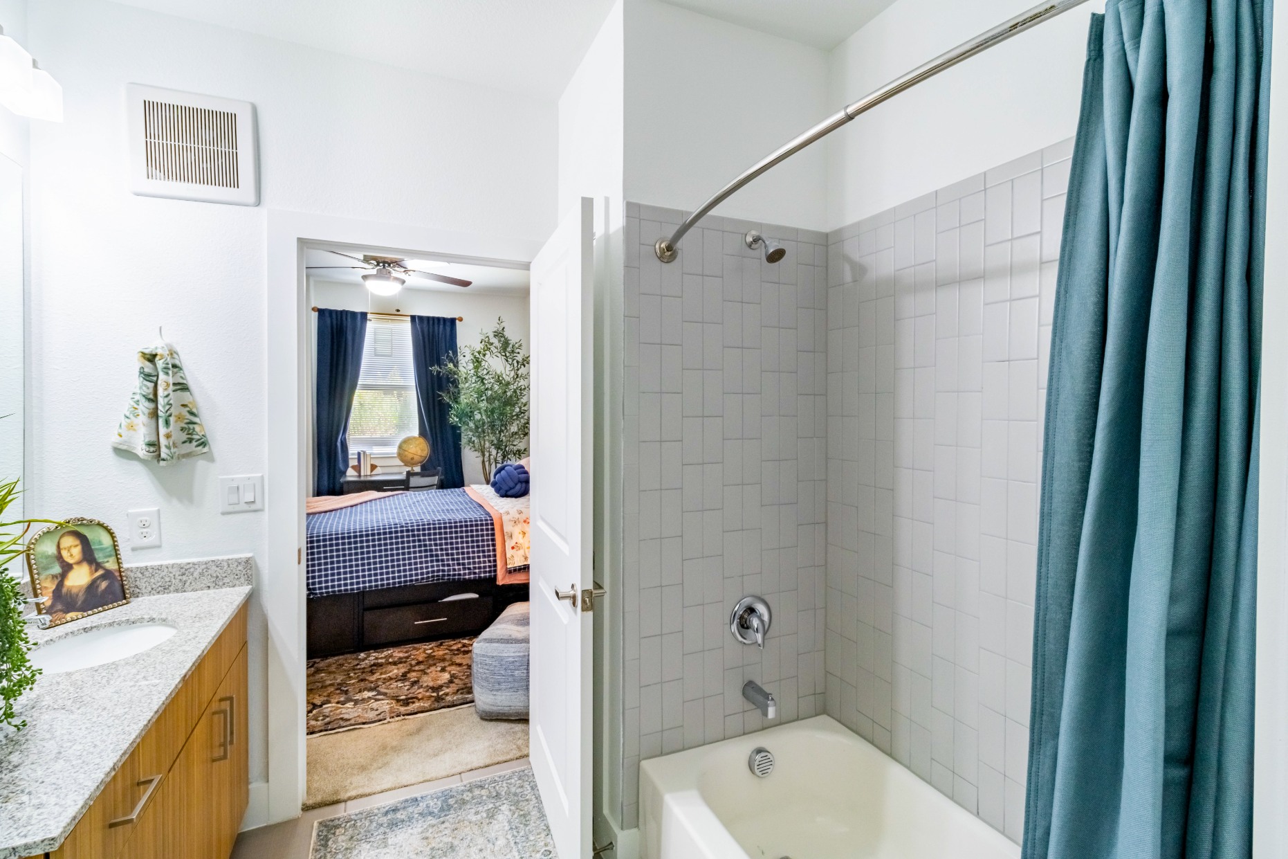 Model bathroom with full tub shower at Pointe San Marcos