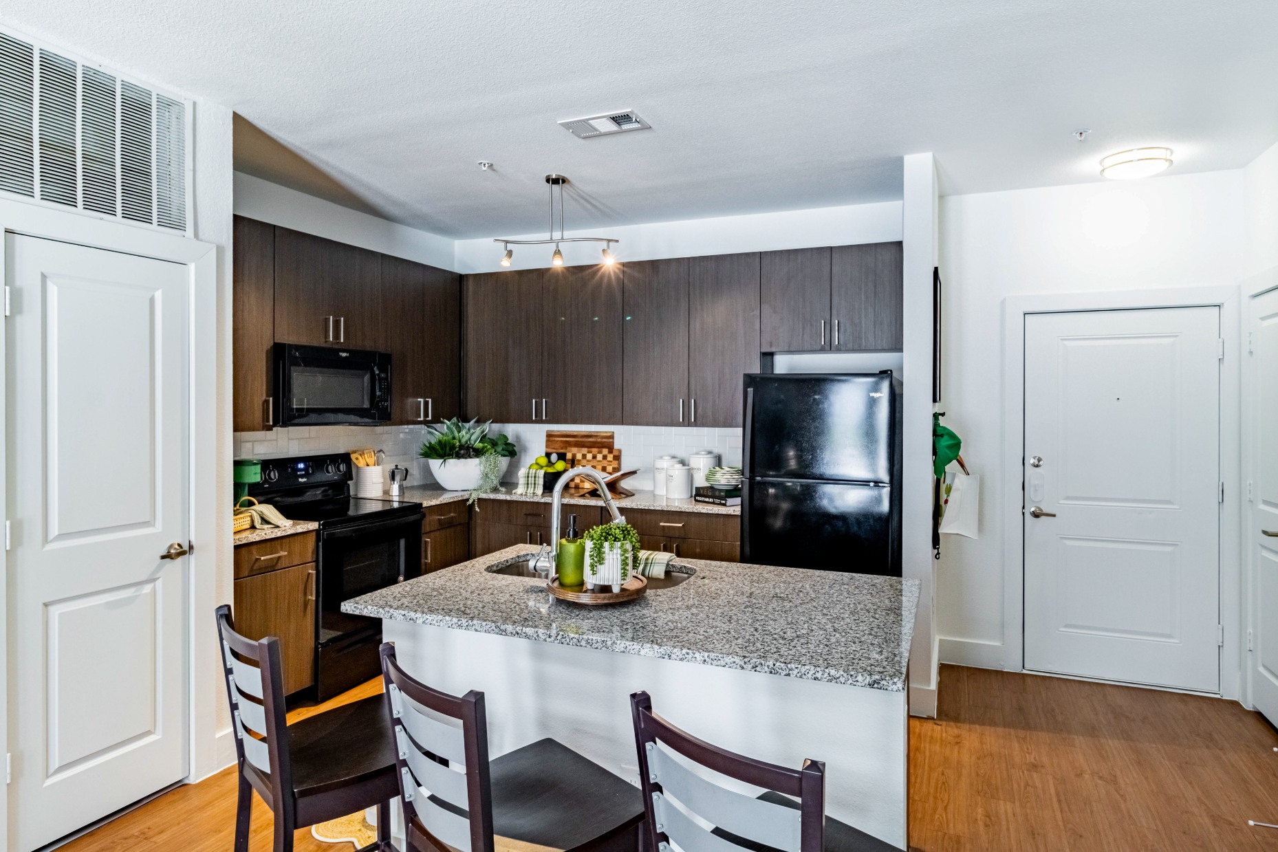 Standard model kitchen with island seating at Pointe San Marcos