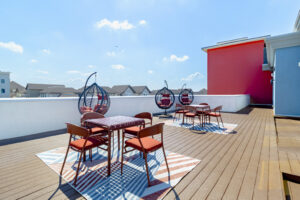 Terrace with tables and lounge chairs at Pointe San Marcos
